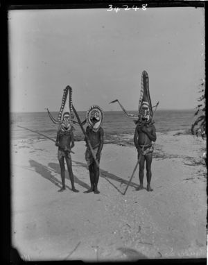 Three men in large painted masks standing on beach (see also RAI No. 34247) Three men in large painted masks standing on beach (see also RAI No. 34247)